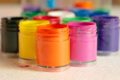 Close-up of colorful watercolor paints bottles on table
