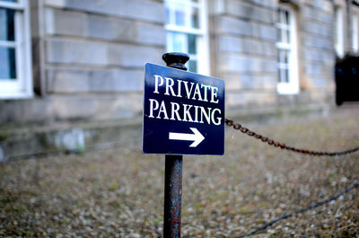 Information sign on road by building