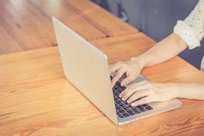 High angle view of woman using laptop on table