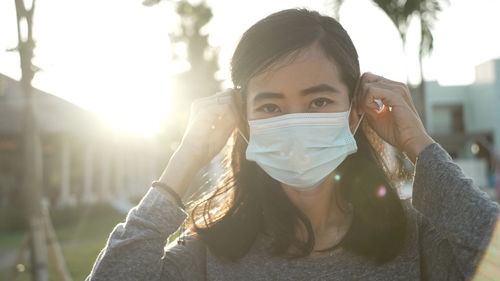 Portrait of young woman drinking outdoors