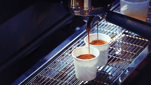 Close-up of pouring coffee in cup