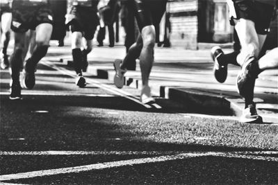 Low section of people walking on road