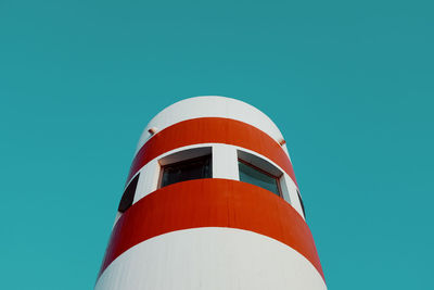 Low angle view of lighthouse against clear blue sky