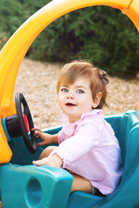 Cute baby girl sitting at park