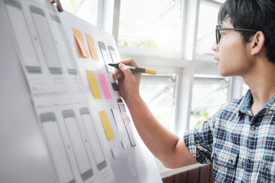 Close-up of young man working in office