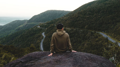 Rear view of man standing against mountain