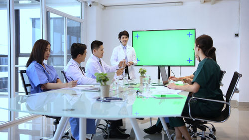 Group of people sitting on table