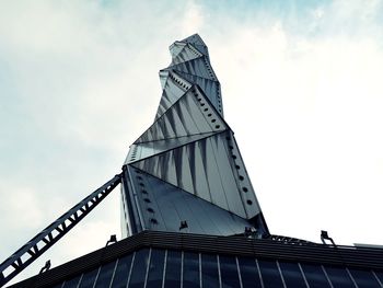 Low angle view of building against cloudy sky