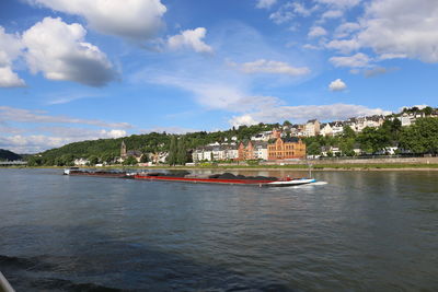 Scenic view of sea by buildings against sky