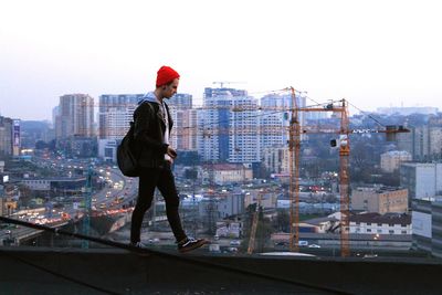 Man walking on buildings terrace in city