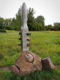 Stone structure on field against clear sky