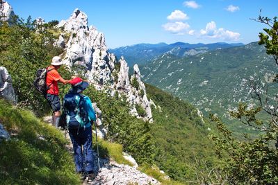 Panoramic shot of people on mountain against sky