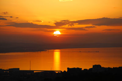 Scenic view of sea against romantic sky at sunset