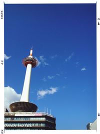 Low angle view of communications tower against blue sky