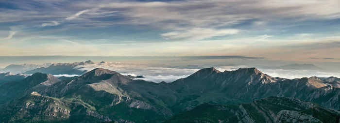 Scenic view of snowcapped mountains against sky during sunset