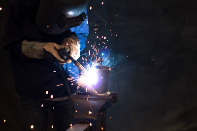 Man working in illuminated machine