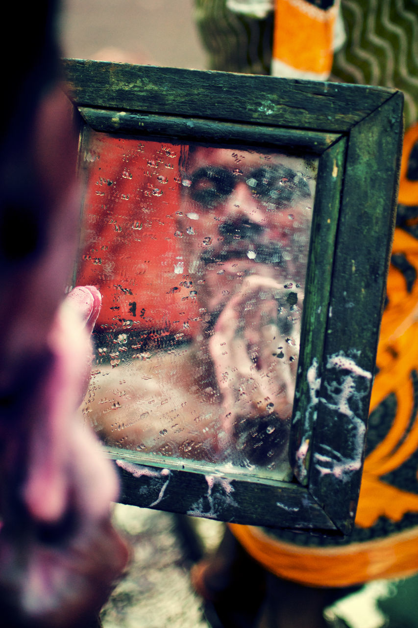 one person, glass - material, close-up, real people, selective focus, technology, water, window, holding, photography themes, mode of transportation, day, wet, men, reflection, photographing, lifestyles, occupation, outdoors, rain