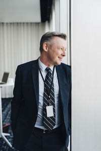 Smiling confident entrepreneur standing in office