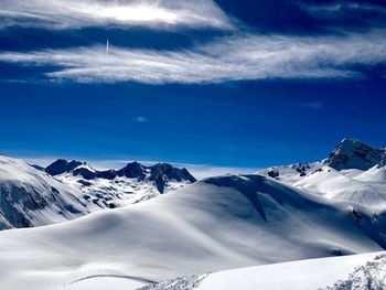 Scenic view of snowcapped mountains against sky