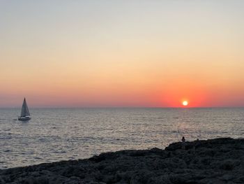 Scenic view of sea against clear sky during sunset