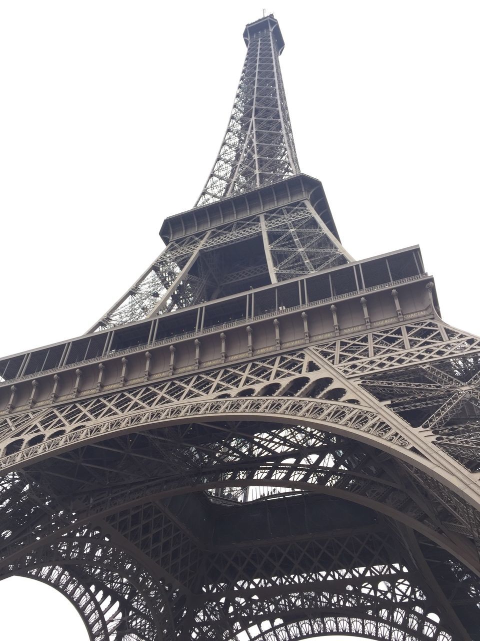 famous place, international landmark, eiffel tower, architecture, built structure, travel destinations, tourism, culture, travel, capital cities, low angle view, history, tower, clear sky, tall - high, architectural feature, metal, building exterior, monument, sky