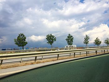 Bridge over sea against cloudy sky