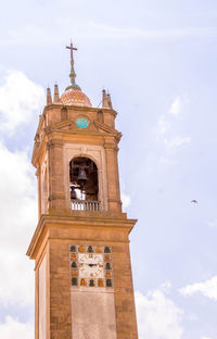 Low angle view of clock tower against sky