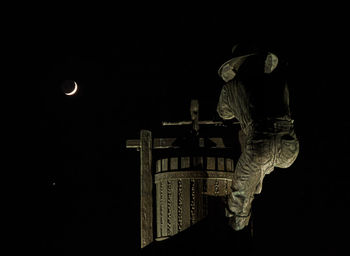 Low angle view of statue against black background