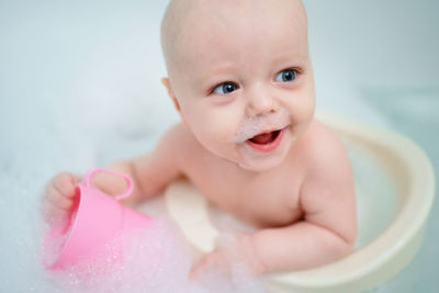 Baby bathes in the bathroom