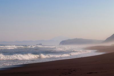 Scenic view of sea against clear sky during sunset