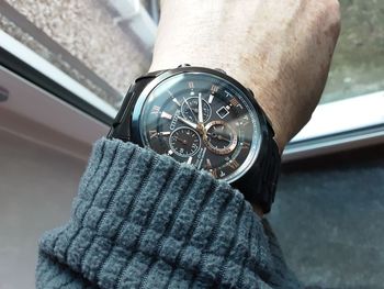 Close-up of hand holding glass against blurred background