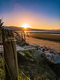 Scenic view of beach against sky during sunset