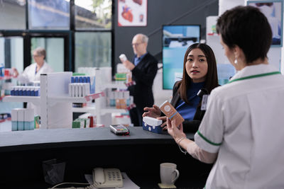 Businesswoman using mobile phone in office