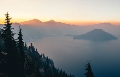 Scenic view of silhouette mountains against sky during sunset