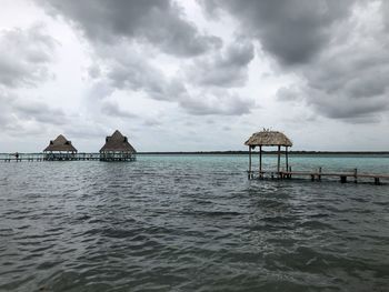 Lifeguard hut by sea against sky