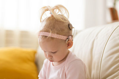 High angle view of baby girl sleeping on bed at home