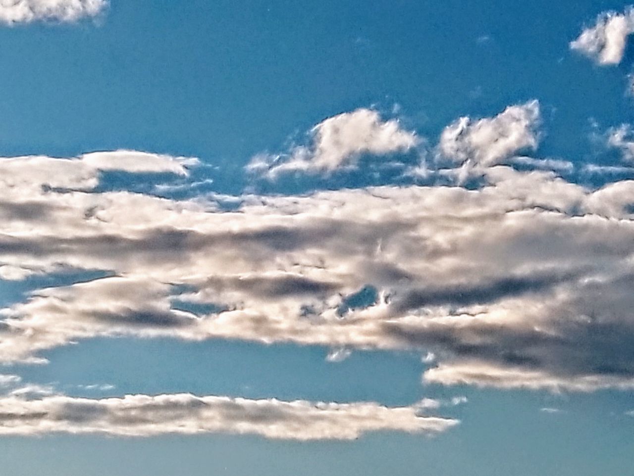 sky, cloud, blue, beauty in nature, nature, environment, no people, scenics - nature, day, tranquility, outdoors, horizon, sunlight, daytime, cloudscape, idyllic, backgrounds, flying, white, tranquil scene, landscape, travel, dramatic sky