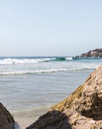 Scenic view of beach and sea against clear sky