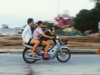 Full length of young woman on road against sky