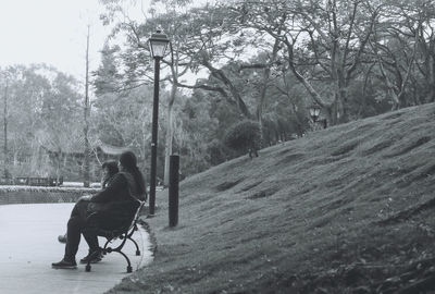 Man with dog sitting on landscape