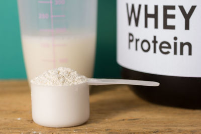 Close-up of whey protein in spoon on table