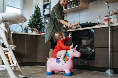 Cozy christmas at home. family preparation holiday dessert. mother and baby toddler daughter play