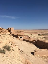 Low angle view of desert building against clear blue sky