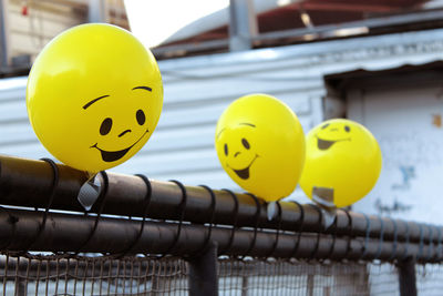 Close-up of yellow ball on metal structure