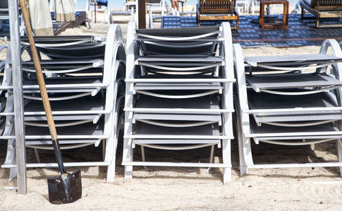 Empty chairs and tables arranged in row