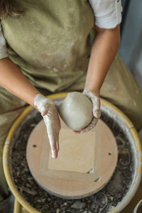 Woman making pottery on the wheel