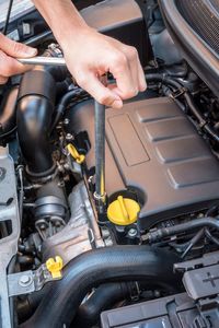 Cropped image of man repairing car engine