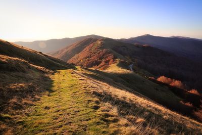 Scenic view of landscape against clear sky during sunset
