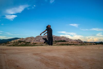 Man standing on landscape against sky