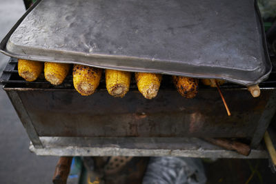 Grilled fresh sweet corn on the grille, ready to serve.closeup yellow corn 